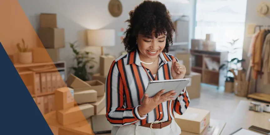 woman holding tablet with boxes in the background